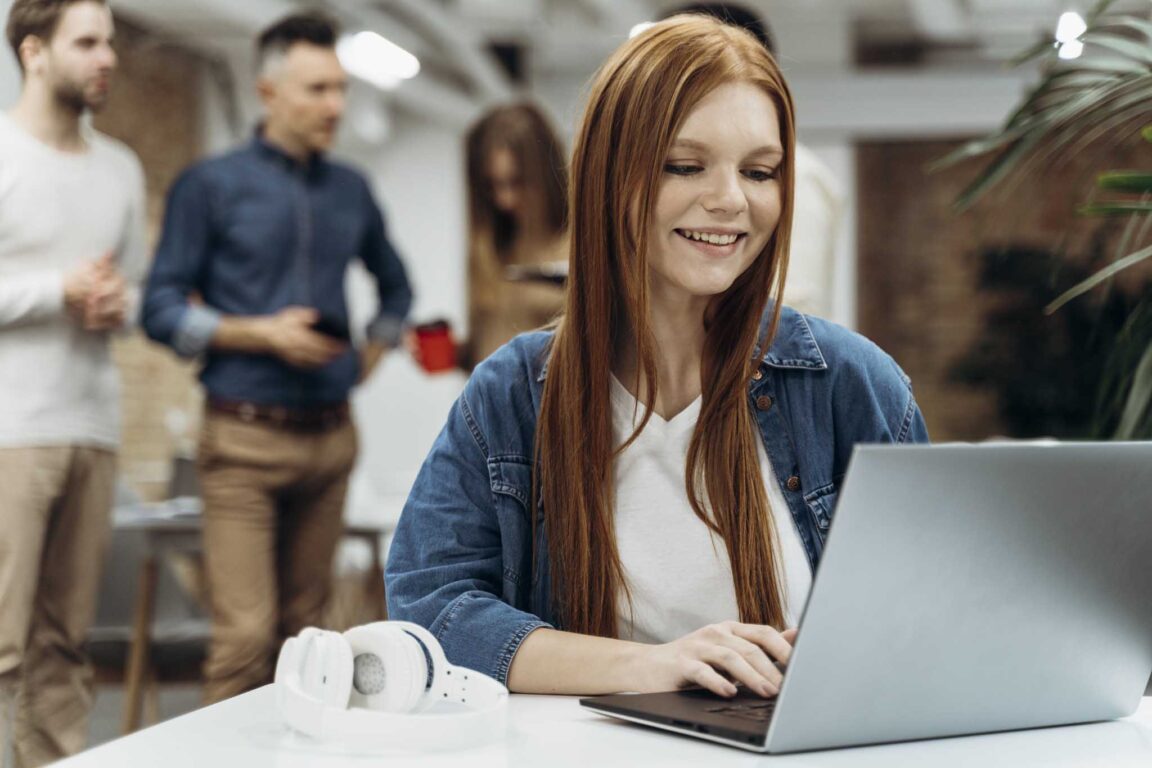 IT young professional working on a laptop in a office.